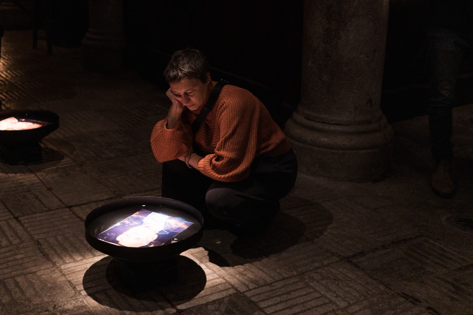 Le Frequenze della memoria, una visitatrice in ascolto davanti a un ritratto